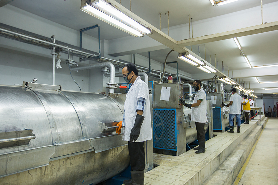 Workers operating washing equipment
